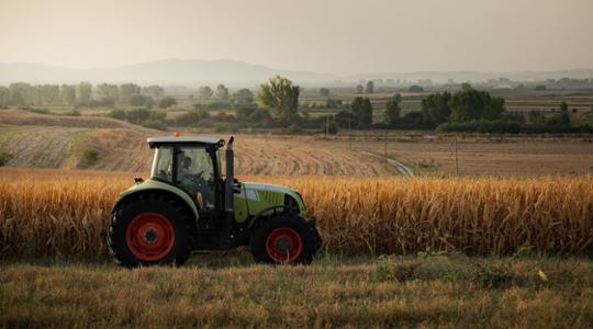 Spreader on a maize field