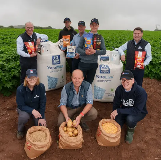 Yara and Pepsico staff in a field 